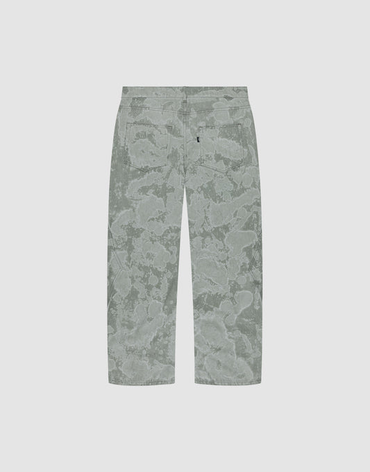 Back view of the Rhomb Wide Denim by LIVE FAST DIE YOUNG: baggy, light grey-green pants with an abstract floral/cloud pattern and two back pockets, featuring wide straight legs. Made from 100% cotton and shown on a plain light background.