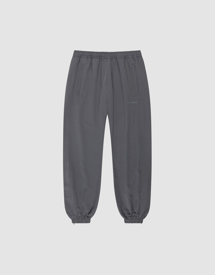 The LFDY Trackpants by LIVE FAST DIE YOUNG are dark gray joggers in a regular fit with an elastic waistband, cuffs, side pockets, polyester blend fabric, and subtle reflektierender Druck detail, shown on a plain light gray background. | plain