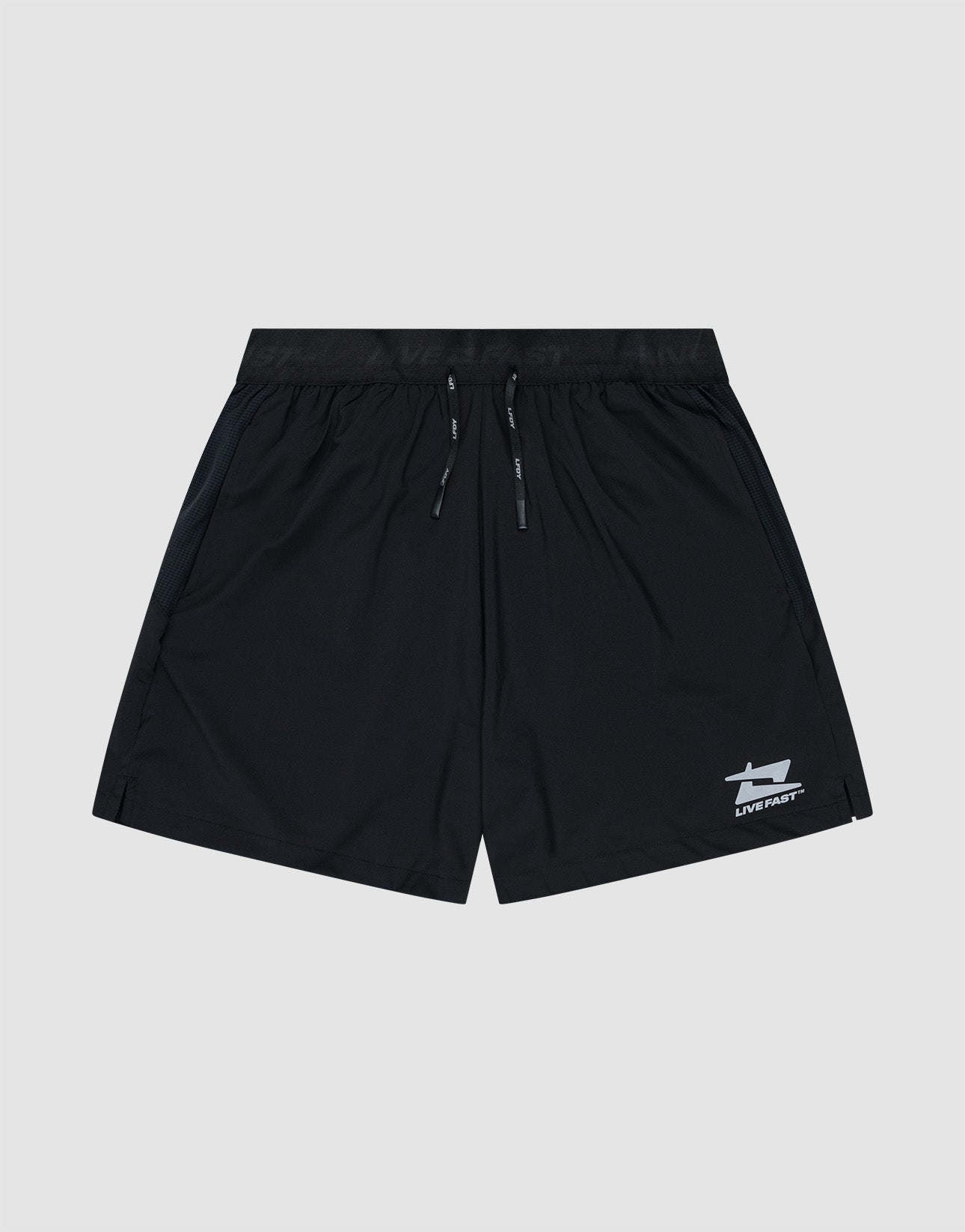 The LIVE FAST DIE YOUNG Live Fast Performance Shorts feature a black design with an elastic waistband, drawstring, and small white reflective logo near the left hem. Shown on a light gray background. Regular Fit offers all-day comfort.| plain