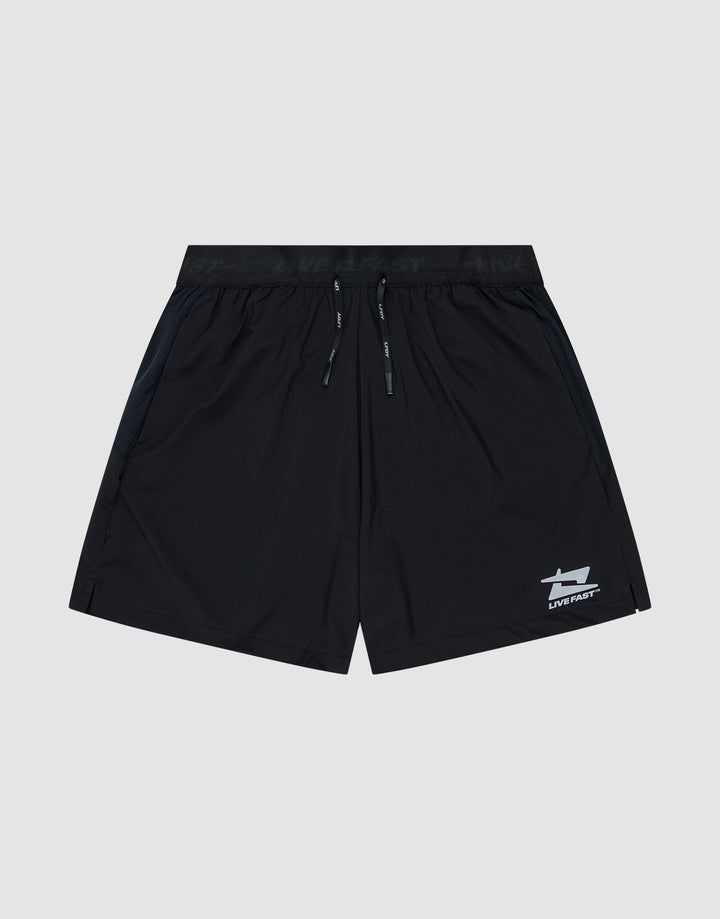 The LIVE FAST DIE YOUNG Live Fast Performance Shorts feature a black design with an elastic waistband, drawstring, and small white reflective logo near the left hem. Shown on a light gray background. Regular Fit offers all-day comfort.| plain