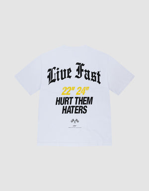 The LFDY Haters Tee by LIVE FAST DIE YOUNG is a white Oversize Fit T-shirt in 100% Baumwolle, featuring bold black 'Live Fast' text and '22” 24” HURT THEM HATERS' print in black/yellow, with small logos and front/back prints. | plain