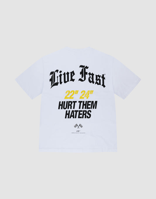 The LFDY Haters Tee by LIVE FAST DIE YOUNG is a white Oversize Fit T-shirt in 100% Baumwolle, featuring bold black 'Live Fast' text and '22” 24” HURT THEM HATERS' print in black/yellow, with small logos and front/back prints. | plain