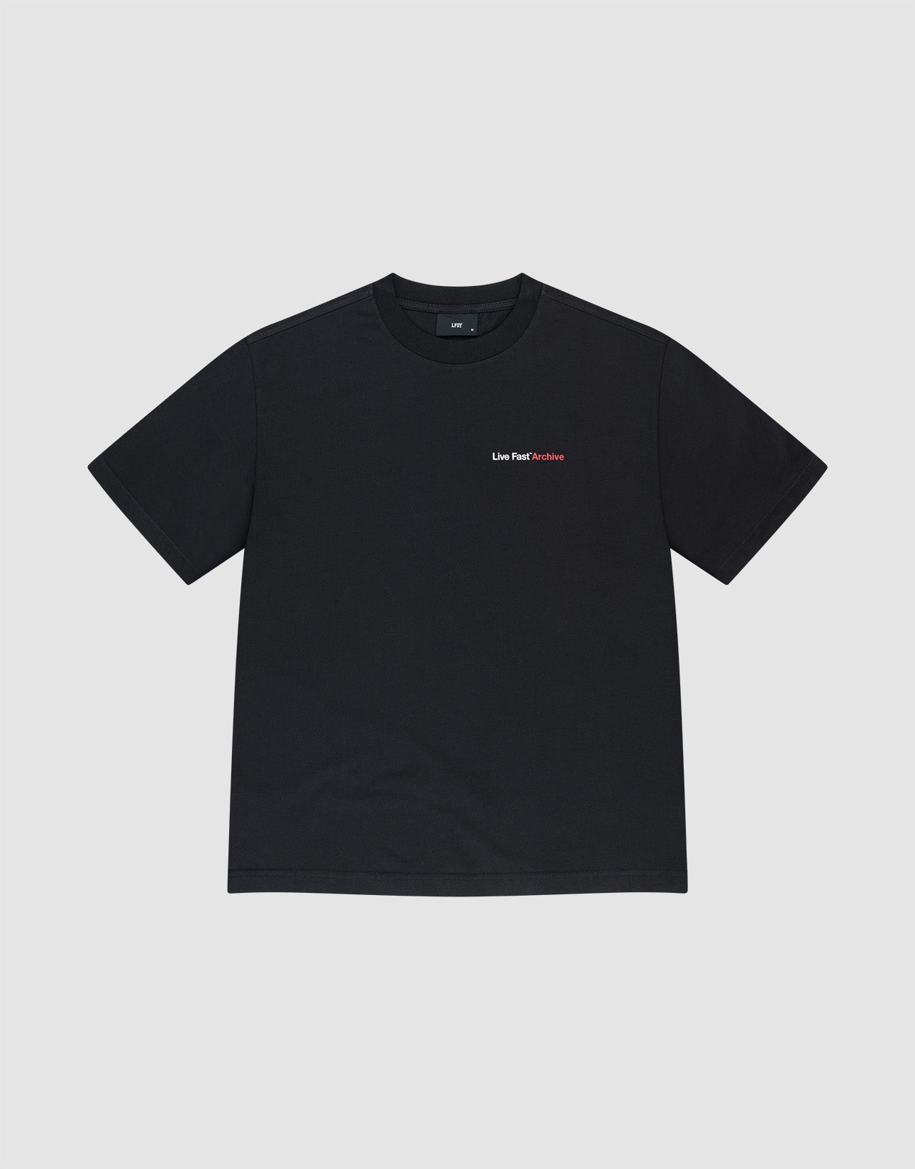 The LFDY F*ck Phones Tee by LIVE FAST DIE YOUNG is a black oversize fit cotton T-shirt featuring “Live Fast” in white and “Fetiche” in red on the left chest, displayed against a plain light gray background.