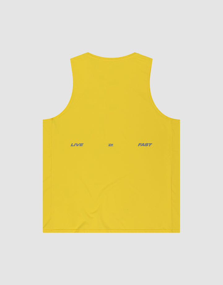 The LIVE FAST DIE YOUNG Live Fast Performance Tank is a yellow sleeveless slim fit top in nylon spandex, featuring "LIVE" and "FAST" printed in gray on the back with a small gray symbol, set against a light gray background.
