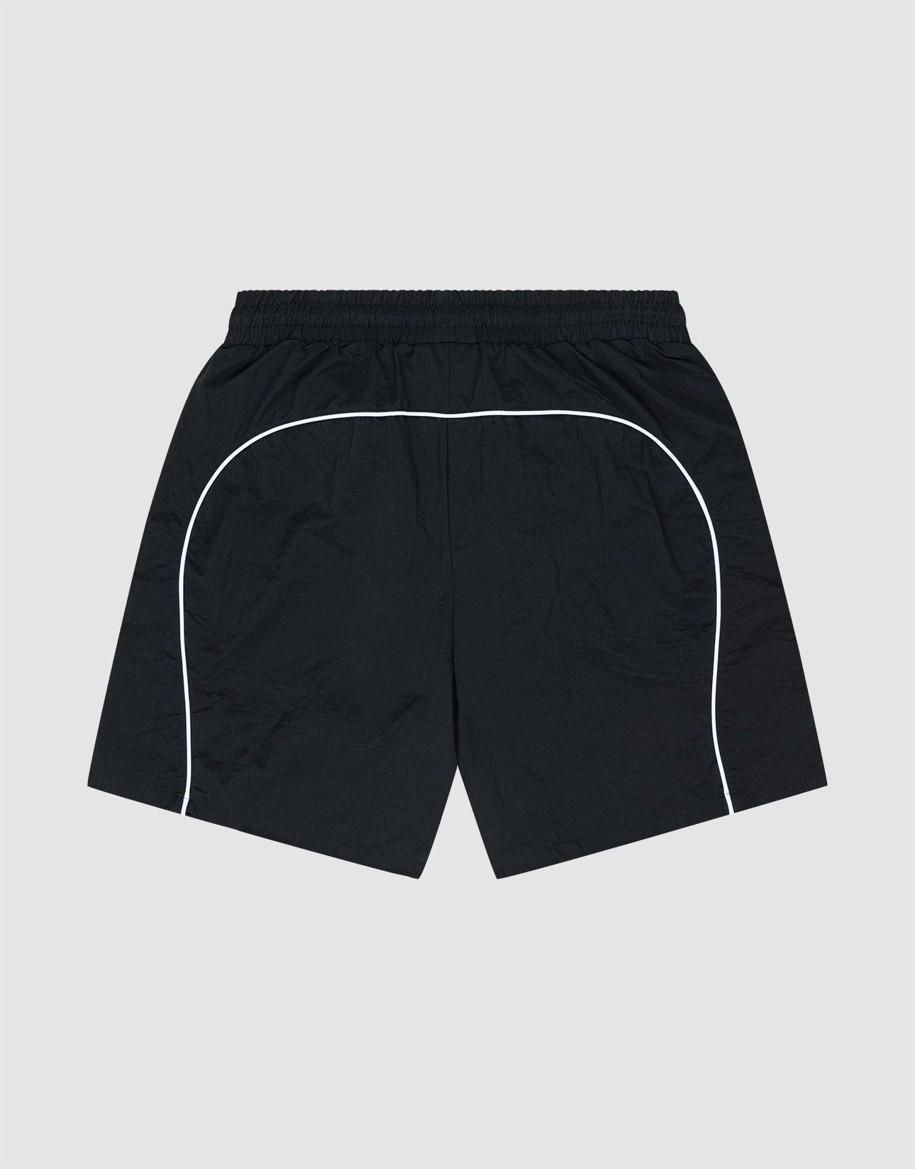 LIVE FAST DIE YOUNG Beach Shorts—black athletic swimwear with an elastic waistband and white curved piping along the sides and back in a Regular Fit, shown on a plain light gray background.