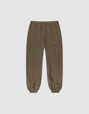 The LFDY Trackpants by LIVE FAST DIE YOUNG feature a regular fit, elastic waistband and cuffs, two side pockets, and a small reflective white logo on the left thigh. Made from soft polyester, shown on a light gray background. | plain