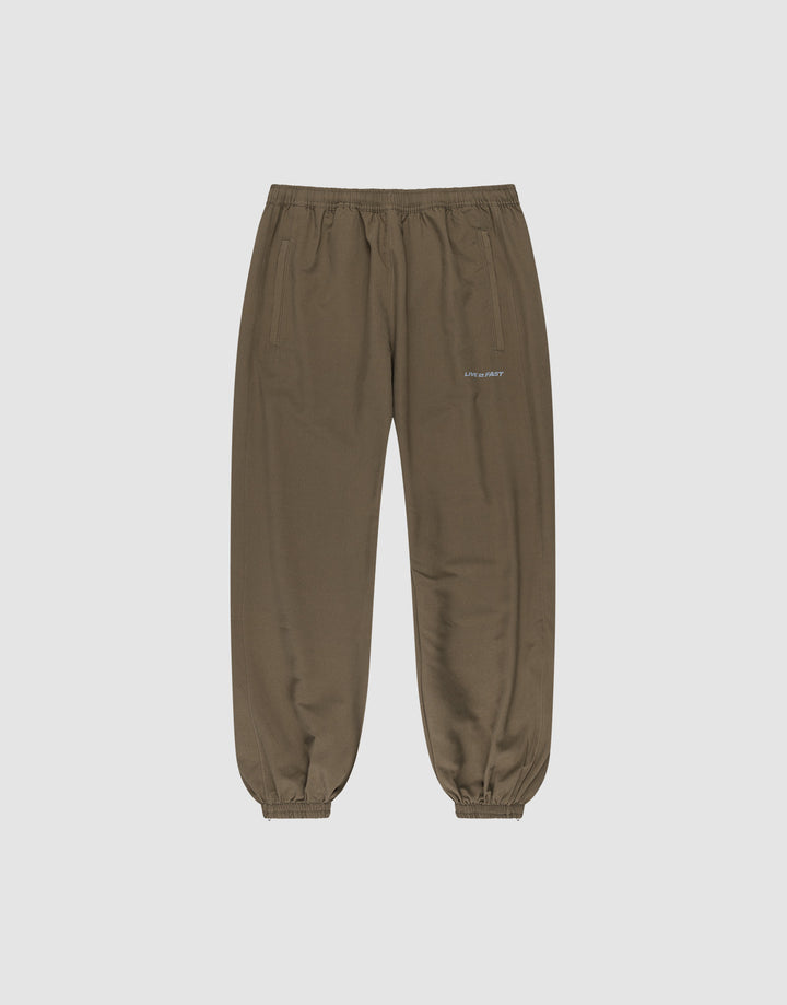 The LFDY Trackpants by LIVE FAST DIE YOUNG feature a regular fit, elastic waistband and cuffs, two side pockets, and a small reflective white logo on the left thigh. Made from soft polyester, shown on a light gray background. | plain