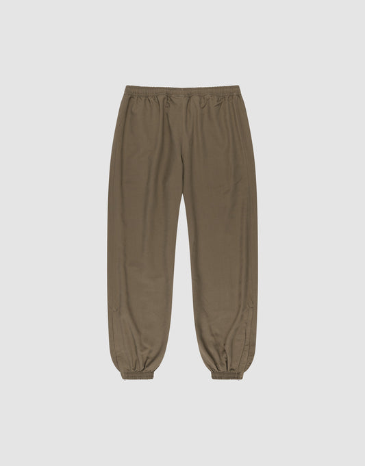 The LFDY Trackpants by LIVE FAST DIE YOUNG are olive green jogger-style pants with an elastic waistband and cuffs, made from polyester in a regular fit, shown on a plain white background.