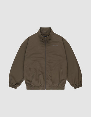 The LFDY Trackjacket by LIVE FAST DIE YOUNG is a brown zip-up with a stand collar, elastic cuffs and hem, oversize fit, two side pockets, and small white "LIMPIDUNIT" text on the left chest. Displayed on a plain white background. | plain
