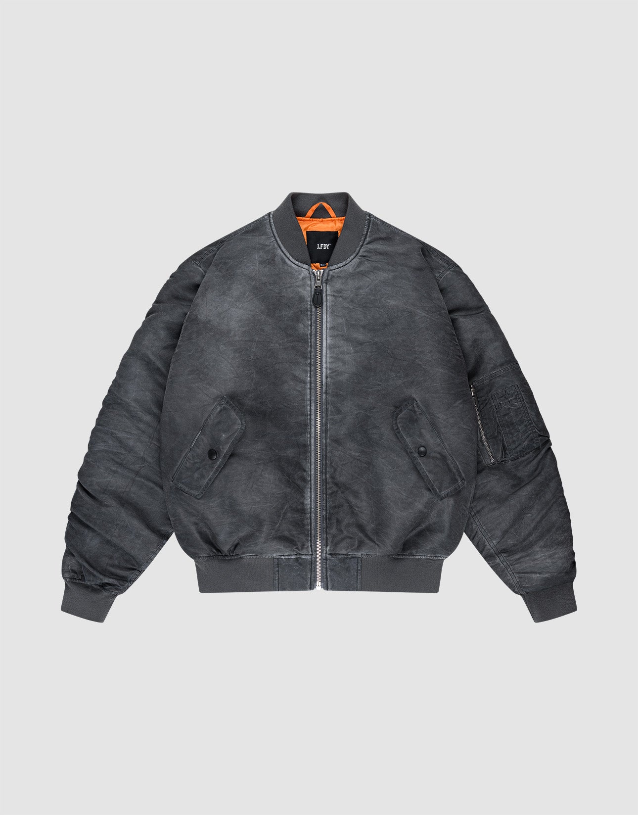 The Washed Bomber Jacket from LIVE FAST DIE YOUNG features a dark gray vintage look, front zipper, ribbed cuffs and hem, two snap pockets, orange collar lining, and a regular polyester fit. Shown on a plain light background. | plain