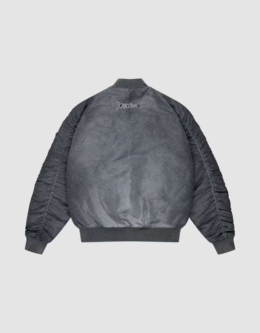 The LIVE FAST DIE YOUNG Washed Bomber Jacket features a regular fit, ribbed collar, cuffs, and hem, subtle sleeve seams, and a small embroidered patch at the upper back. Shown from the back in gray polyester for a vintage look.