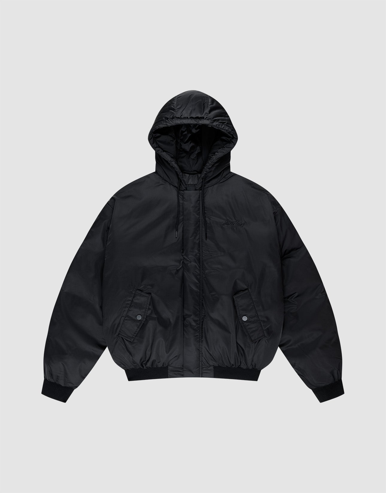 The LFDY Winter Bomber Jacket by LIVE FAST DIE YOUNG is a black oversized puffer with a hood and drawstrings, front snap-button pockets, ribbed cuffs, and hem, shown on a light gray background.