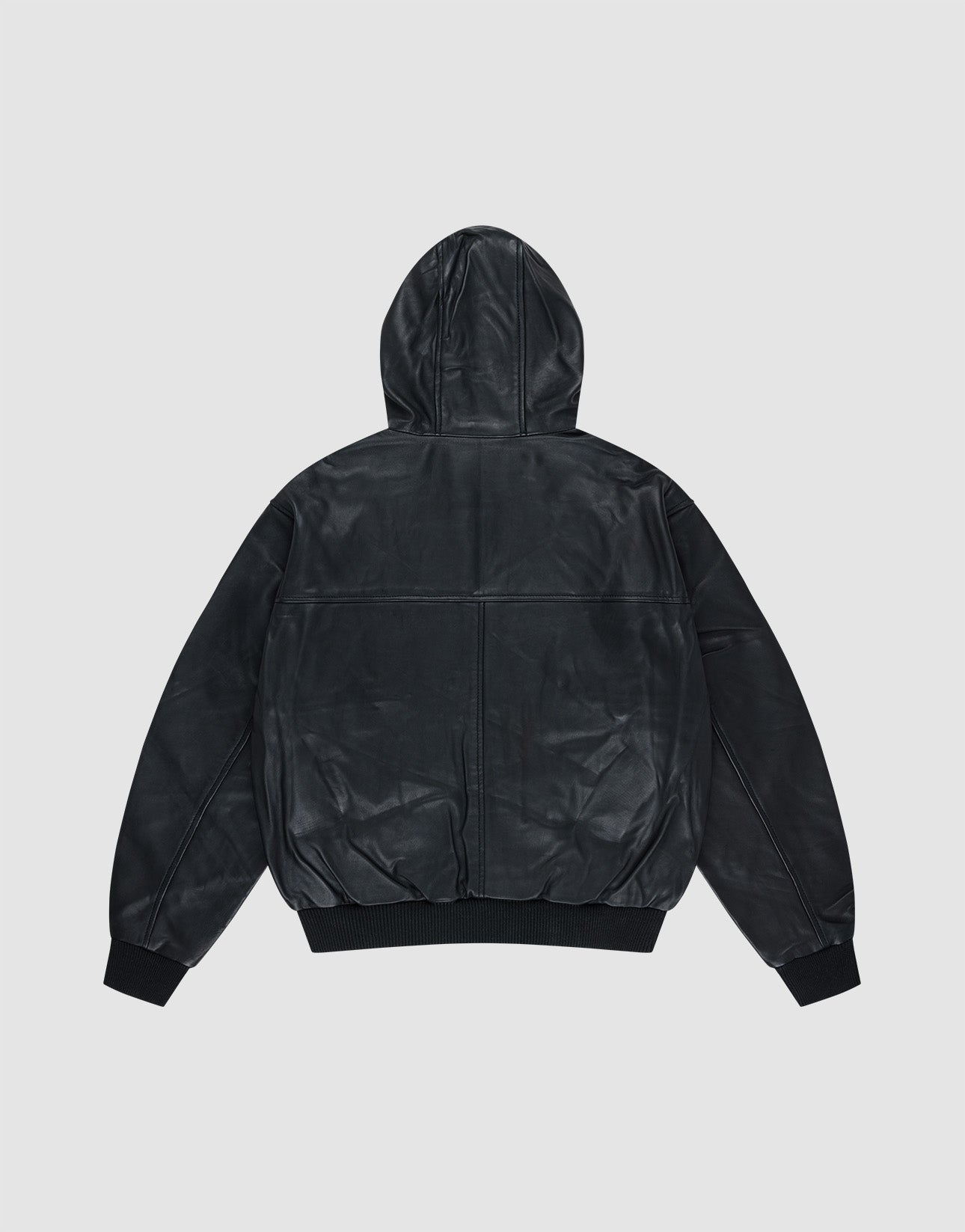 The LIVE FAST DIE YOUNG Leather Hooded Jacket in black Lammleder is shown from the back, highlighting its smooth finish, ribbed cuffs, and waistband against a plain light gray background.
