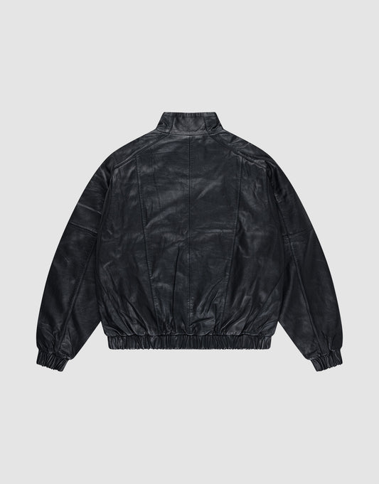 The Live Fast Leather Trackjacket by LIVE FAST DIE YOUNG is shown from the back on a light gray background, featuring a stand collar, relaxed fit, elastic cuffs and waistband, plus a subtly embossed logo.