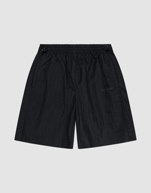 The LIVE FAST DIE YOUNG Live Fast Nylon Shorts feature an oversized fit, elastic waistband (Elastikbund), subtle side pockets, and a slightly wrinkled texture, shown flat on a plain light gray background. | plain