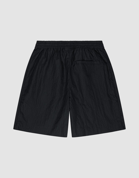 LIVE FAST DIE YOUNG’s Live Fast Nylon Shorts in black feature an oversized fit, an elastic waistband, and a single back pocket. Shown flat on a light gray background with the back view visible.