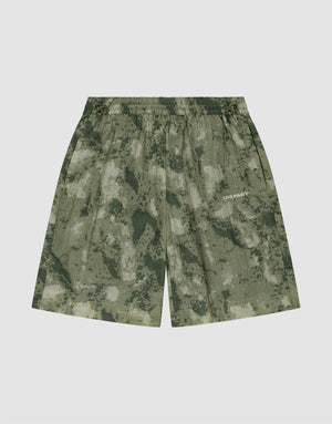 The LIVE FAST DIE YOUNG Live Fast Nylon Shorts feature a green camouflage pattern, elastic waistband, and subtle LIVE FAST silicone print on the right leg, displayed against a plain white background. | plain