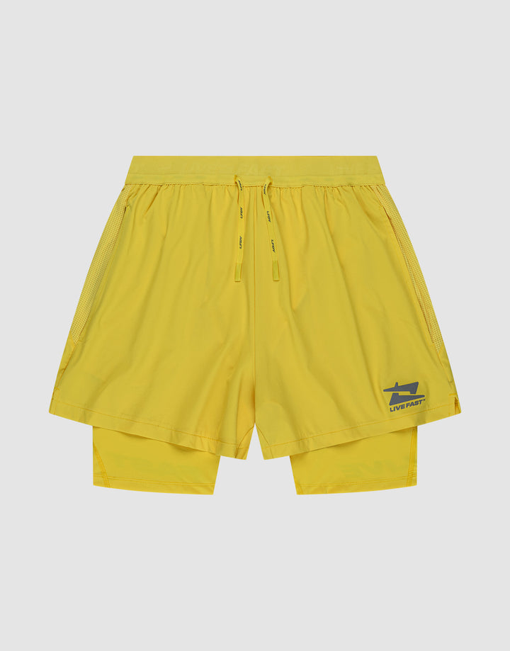 The LIVE FAST DIE YOUNG Live Fast Performance Running Shorts are bright yellow, Regular Fit, with an elastic waistband, drawstrings, double-layer design featuring integrated tights, and a blue shark logo with "LIVE FAST" on the lower left leg. | plain