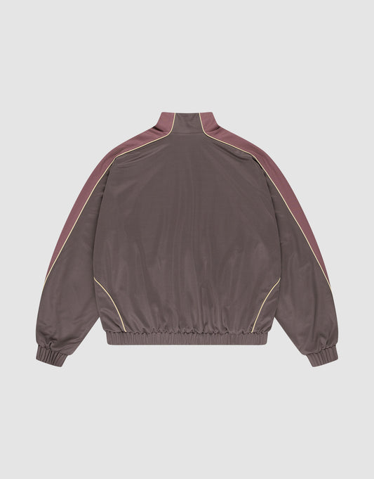 The LFDY x Baba Angora Trackjacket by LIVE FAST DIE YOUNG features a brown oversize fit, high collar, maroon shoulder and sleeve panels, yellow piping, and elastic cuffs and hem, shown on a plain white background.