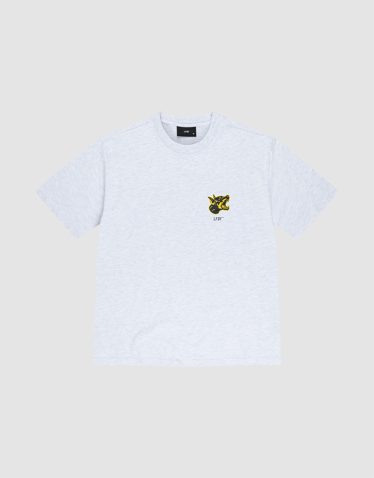 The LFDY Circle Dog Tee by LIVE FAST DIE YOUNG is a light gray, 100% Baumwolle oversize fit t-shirt with short sleeves and a small yellow and black UFO graphic on the left chest, shown on a plain light gray background.