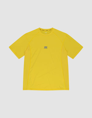 The LIVE FAST DIE YOUNG Live Fast Performance Tee is a bright yellow slim fit short-sleeve athletic shirt made from soft nylon spandex, featuring a small blue and white chest logo, shown on a plain light gray background. | plain