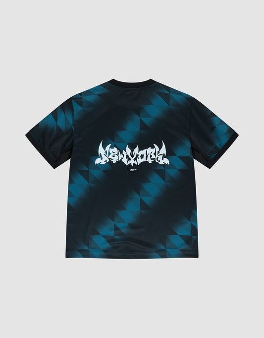 The Live Fast Jersey Tee by LIVE FAST DIE YOUNG is a regular fit football shirt made from 100% polyester, featuring blue and black triangular patterns, graffiti-style white text, and UNITY printed on the back.
