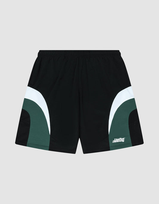 The LIVE FAST DIE YOUNG Basic Trackshorts feature a black oversize fit with dark green and white curved color block side accents, an elastic waistband, and a small white logo print on the lower left leg. Displayed on a light gray background. | plain