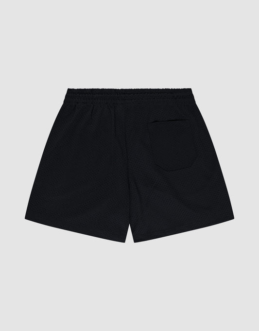 The LIVE FAST DIE YOUNG Basic Mesh Shorts are shown from the back against a plain light gray background. These regular fit black shorts feature a mesh texture, elastic waistband, right back pocket, and a subtle logo patch.