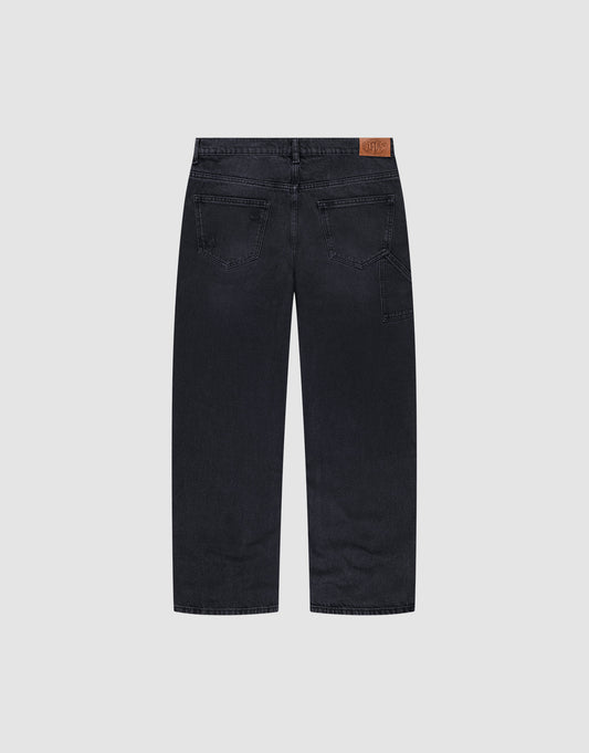 The Oversize Ripped Denim jeans by LIVE FAST DIE YOUNG feature a straight leg, two back pockets, and a brown leather patch on the waistband, shown from the back against a plain light gray background.