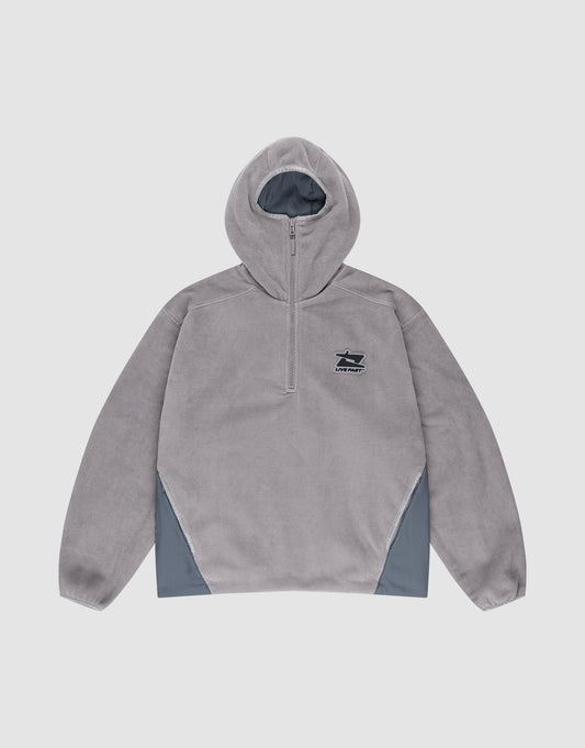 The Live Fast Fleece Halfzip by LIVE FAST DIE YOUNG is a light grey polyester fleece hoodie with an oversized fit, half-zip, long sleeves, small black left chest logo, and darker grey nylon einsatz panels on the lower sides. Plain white background. | plain