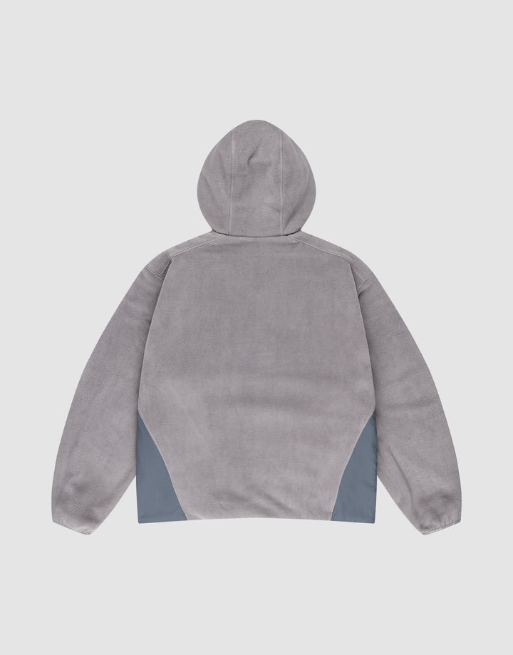 Back view of the LIVE FAST DIE YOUNG Live Fast Fleece Halfzip in light gray, featuring an oversize fit, long sleeves, and dark gray nylon triangular panels at the lower sides, made from polyester on a plain white background.