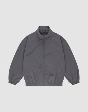 The LFDY Trackjacket by LIVE FAST DIE YOUNG is a gray polyester zip-up with a stand collar, elastic cuffs and hem, oversize fit, chest text detail, and two side pockets, shown on a plain white background. | plain