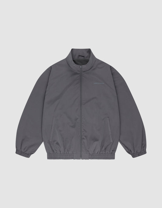 The LFDY Trackjacket by LIVE FAST DIE YOUNG is a gray polyester zip-up with a stand collar, elastic cuffs and hem, oversize fit, chest text detail, and two side pockets, shown on a plain white background. | plain