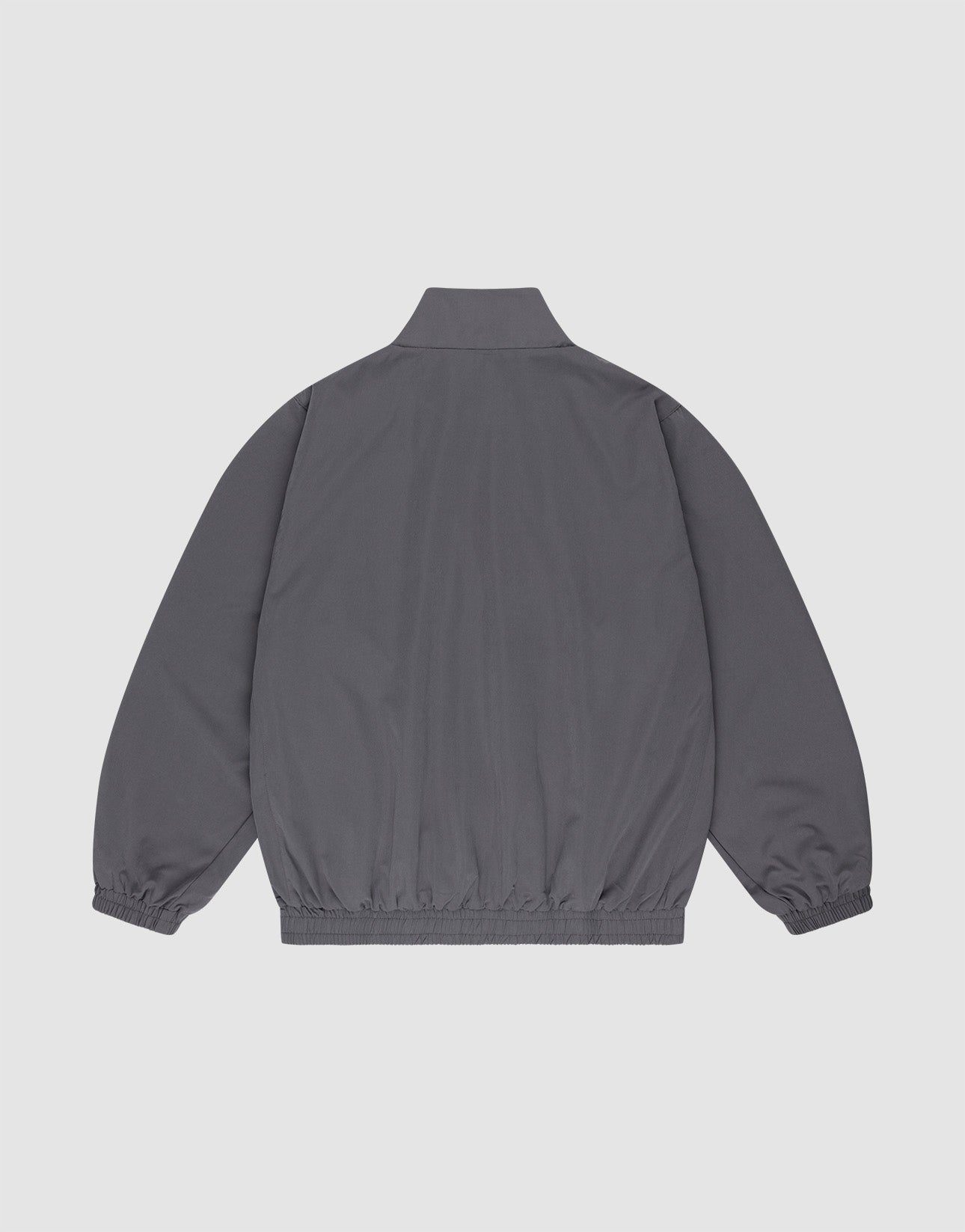 The LFDY Trackjacket by LIVE FAST DIE YOUNG is shown from the back in plain gray polyester with long sleeves, elastic cuffs and waistband, a short stand-up collar, and an oversize fit against a light gray background.