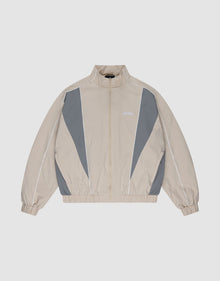 The LIVE FAST DIE YOUNG Basic Nylon Trackjacket in beige and gray features a zip-up front, high collar, white piping, elastic cuffs and hem, and subtle Logo-Stick detail, shown laid flat on a light background. | plain