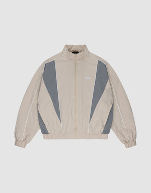 The LIVE FAST DIE YOUNG Basic Nylon Trackjacket in beige and gray features a zip-up front, high collar, white piping, elastic cuffs and hem, and subtle Logo-Stick detail, shown laid flat on a light background. | plain
