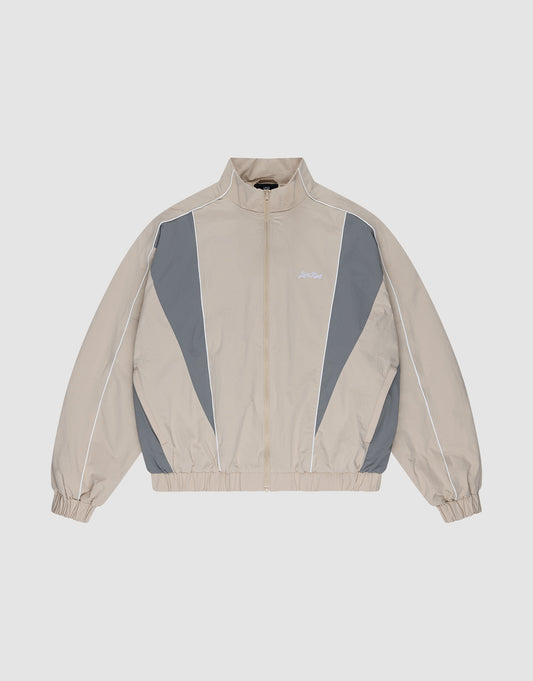 The LIVE FAST DIE YOUNG Basic Nylon Trackjacket in beige and gray features a zip-up front, high collar, white piping, elastic cuffs and hem, and subtle Logo-Stick detail, shown laid flat on a light background. | plain