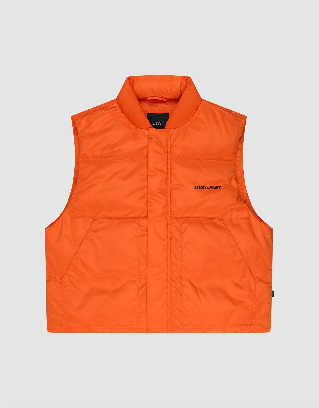 The Live Fast Cropped Vest by LIVE FAST DIE YOUNG is a bright orange sleeveless puffer with a high collar, front snap closure, two large front pockets, and "LIVIN’ FAST" text on the left chest, shown on a plain grey background.