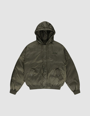 The LFDY Winter Bomber Jacket by LIVE FAST DIE YOUNG features an olive green oversize fit, hood with drawstrings, front snap pockets, ribbed cuffs and hem, and a subtle chest logo stick, shown on a plain light gray background. | plain