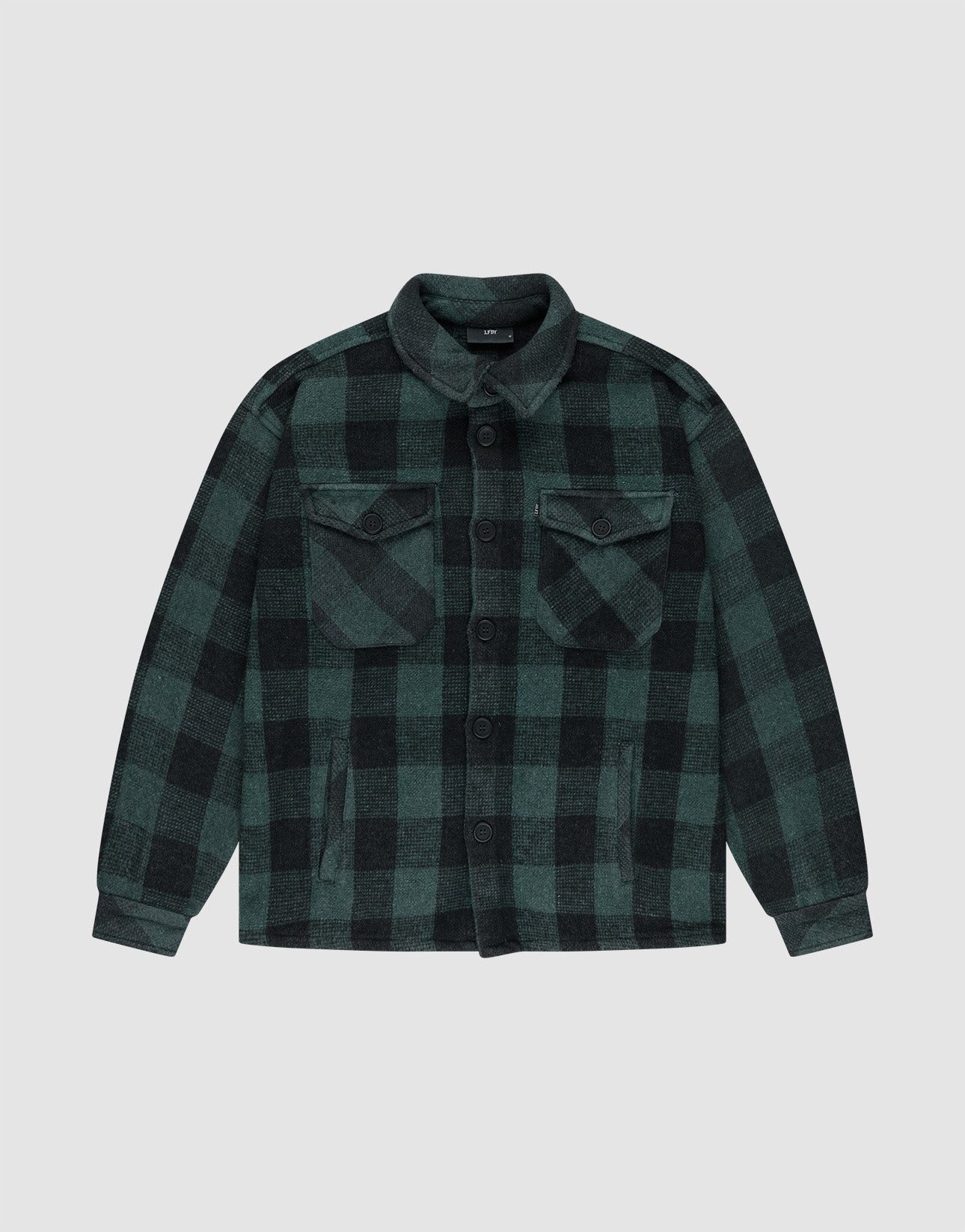 The LIVE FAST DIE YOUNG Heavy Flannel Shacket features green and black plaid, Vintage-Effekt finish, button-down front, flap chest pockets, and side pockets, shown laid flat on a plain light gray background.