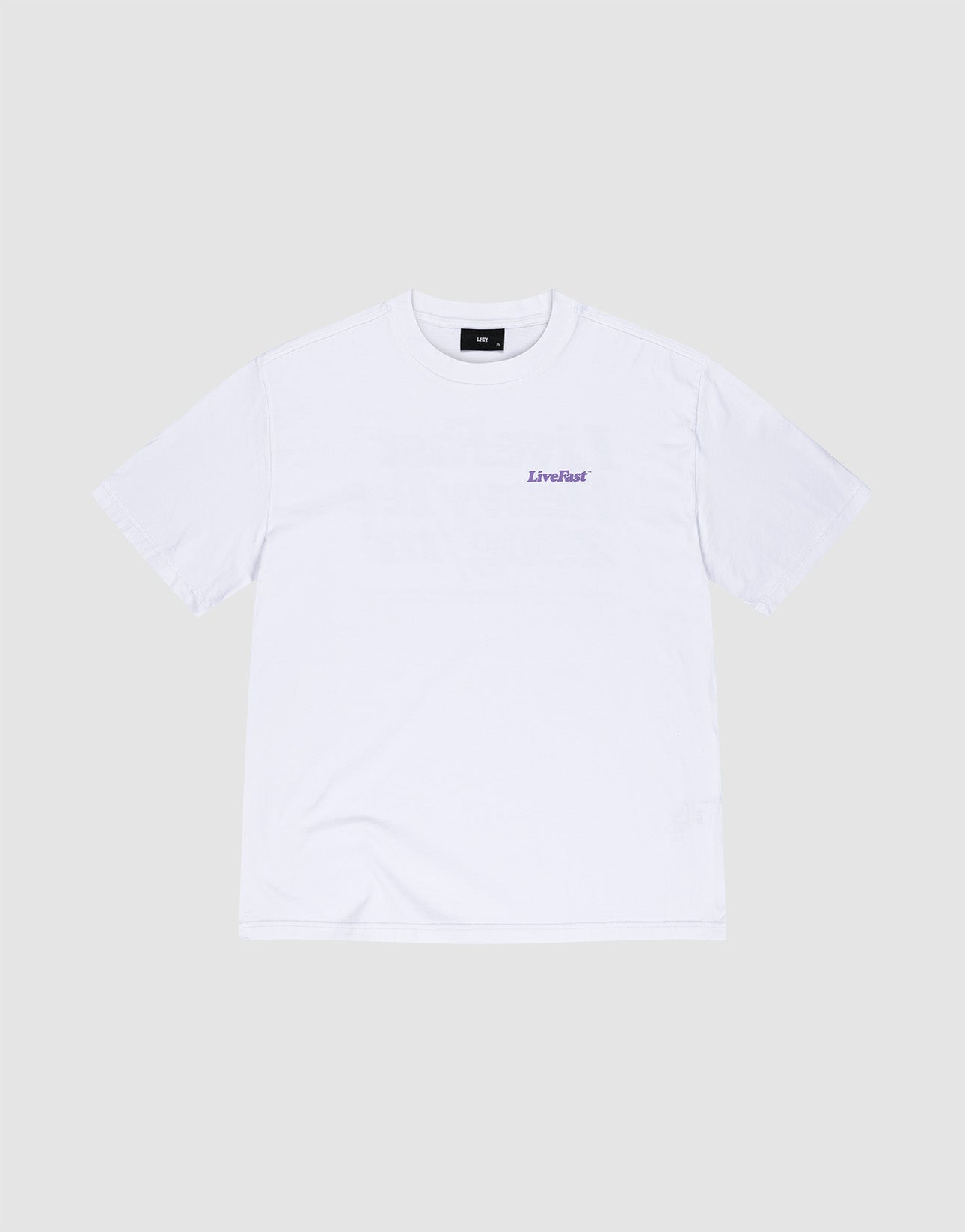 The LIVE FAST DIE YOUNG Basic 280 Tee, an oversize fit white cotton short-sleeve shirt, is laid flat on a light gray background and features a small purple LiveFast logo printed on the left chest.