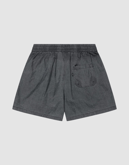 The LIVE FAST DIE YOUNG Live Fast Swimshorts feature a dark gray tinted black wash, elastik-bund waistband, single back flap pocket with two buttons, and lightweight fabric with a slightly wrinkled look in a regular fit.