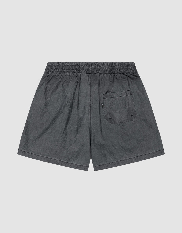 The LIVE FAST DIE YOUNG Live Fast Swimshorts feature a dark gray tinted black wash, elastik-bund waistband, single back flap pocket with two buttons, and lightweight fabric with a slightly wrinkled look in a regular fit.