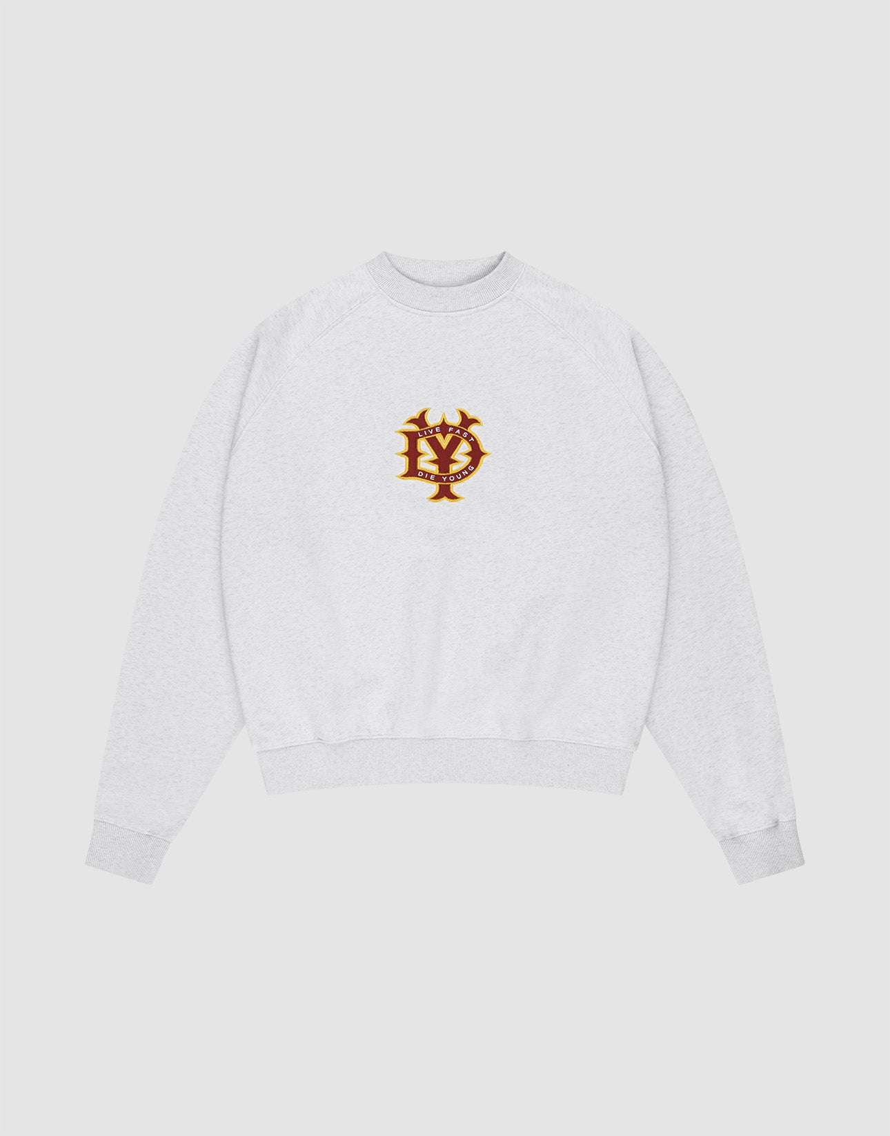 The DY Sweater by LIVE FAST DIE YOUNG is a light gray oversize fit crewneck with ribbed cuffs and hem, raglan sleeves, and a red and gold embroidered NY emblem on the chest, shown on a plain white background.