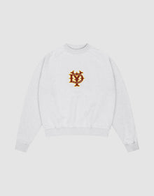 The DY Sweater by LIVE FAST DIE YOUNG is a light gray oversize fit crewneck with ribbed cuffs and hem, raglan sleeves, and a red and gold embroidered NY emblem on the chest, shown on a plain white background. | plain 