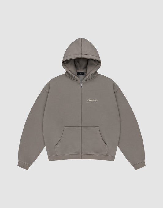 The Basic 510 Hooded Zip by LIVE FAST DIE YOUNG is a plain grey zip-up hoodie with a subtle vintage wash, front pockets, hood, and "LiveFast" in small white text on the left chest, shown flat on a light grey background.