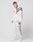 Wearing the LFDY x Trigema Trackjacket by LIVE FAST DIE YOUNG, a person in a white tracksuit with red and navy stripes and Raglanärmel stands against a plain white background, looking down with hands at their sides, paired with white sneakers.
