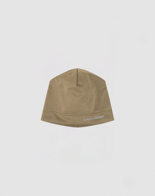 The Live Fast Performance Beanie by LIVE FAST DIE YOUNG is a plain brown fitted beanie with LIVE 2 FAST in white near the edge and a reflective logo print, shown on a light gray background.