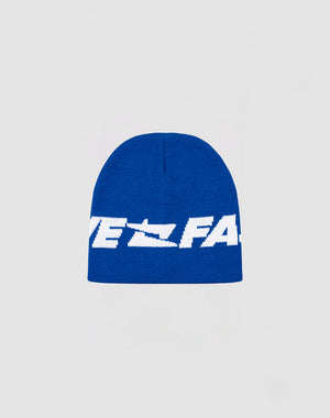 The Live Fast Jacquard Beanie by LIVE FAST DIE YOUNG is a blue knit polyacryl hat with bold white Logo Strick text across the front, shown on a plain light gray background. Style code: LF2410-16488.