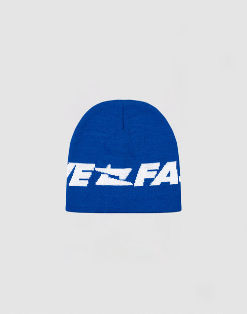 The Live Fast Jacquard Beanie by LIVE FAST DIE YOUNG is a blue knit polyacryl hat with bold white Logo Strick text across the front, shown on a plain light gray background. Style code: LF2410-16488.